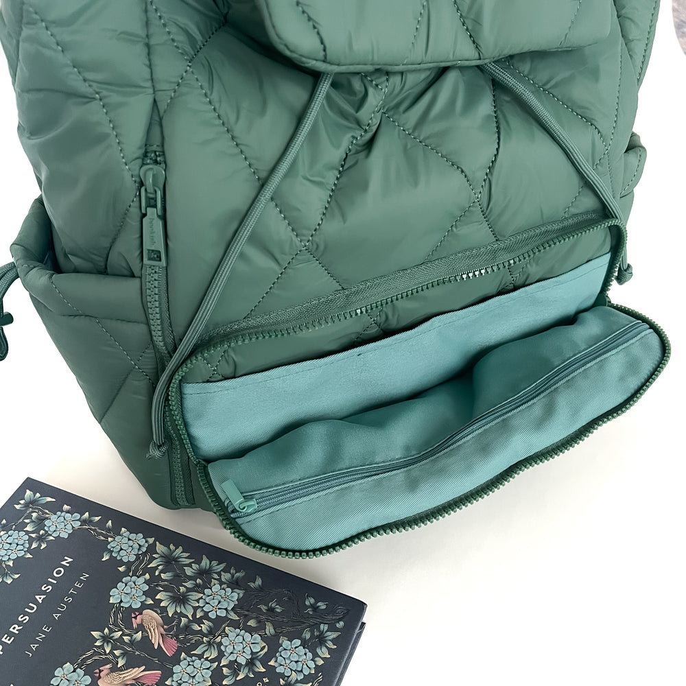 Green quilted bookish backpack with a book titled 'Persuasion' by Jane Austen on a white background